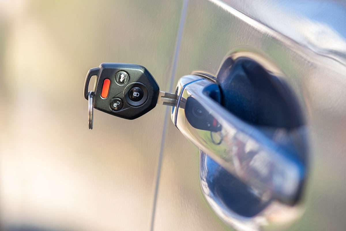 Car key inserted in vehicle door lock.
