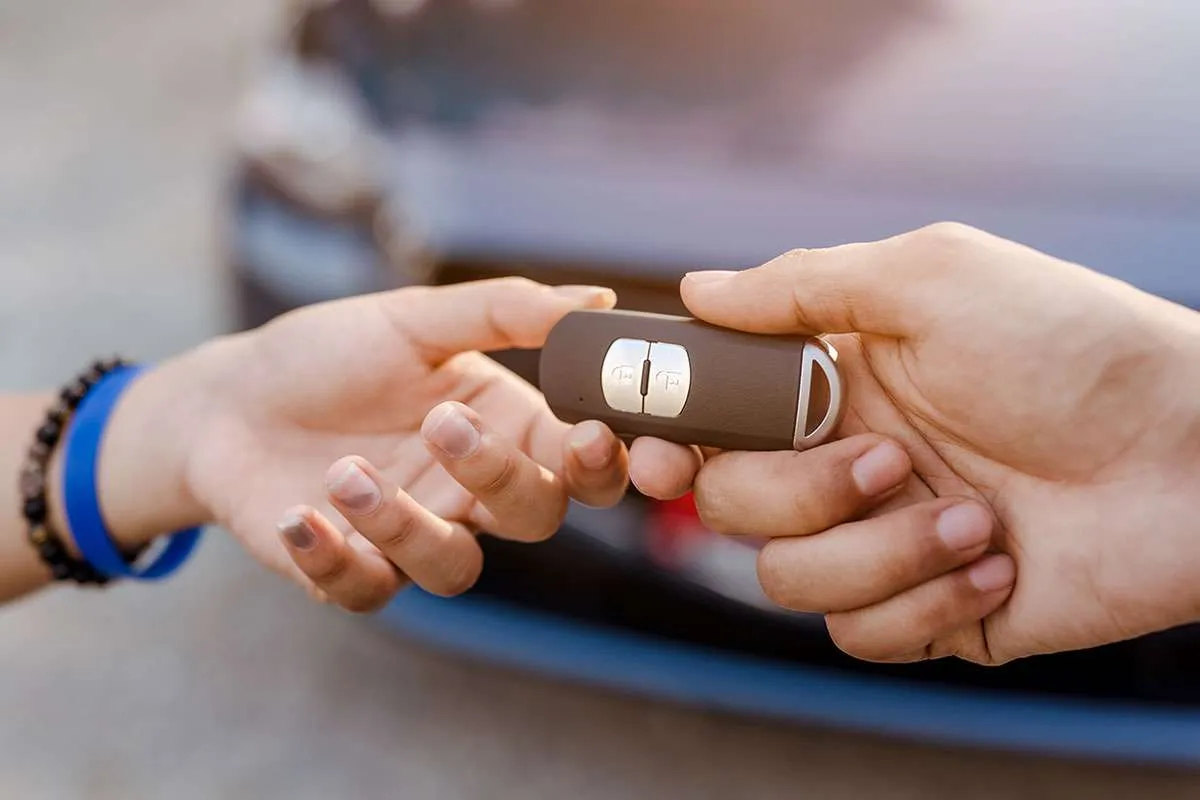 Handing over car keys.