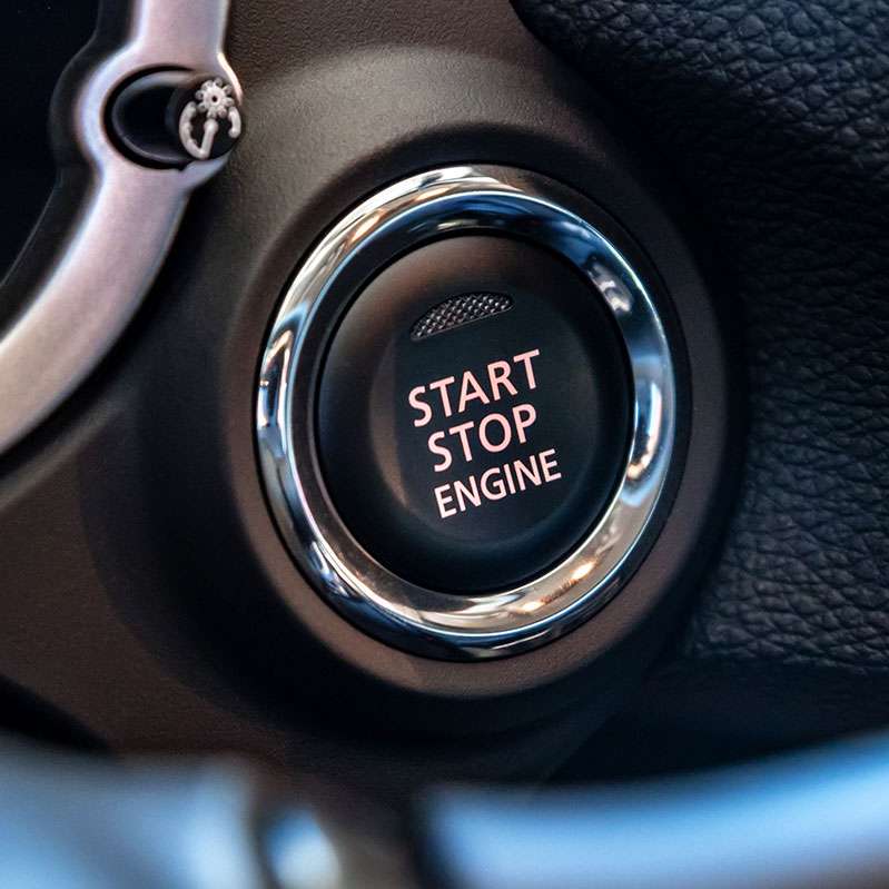 Car's start-stop engine button close-up.