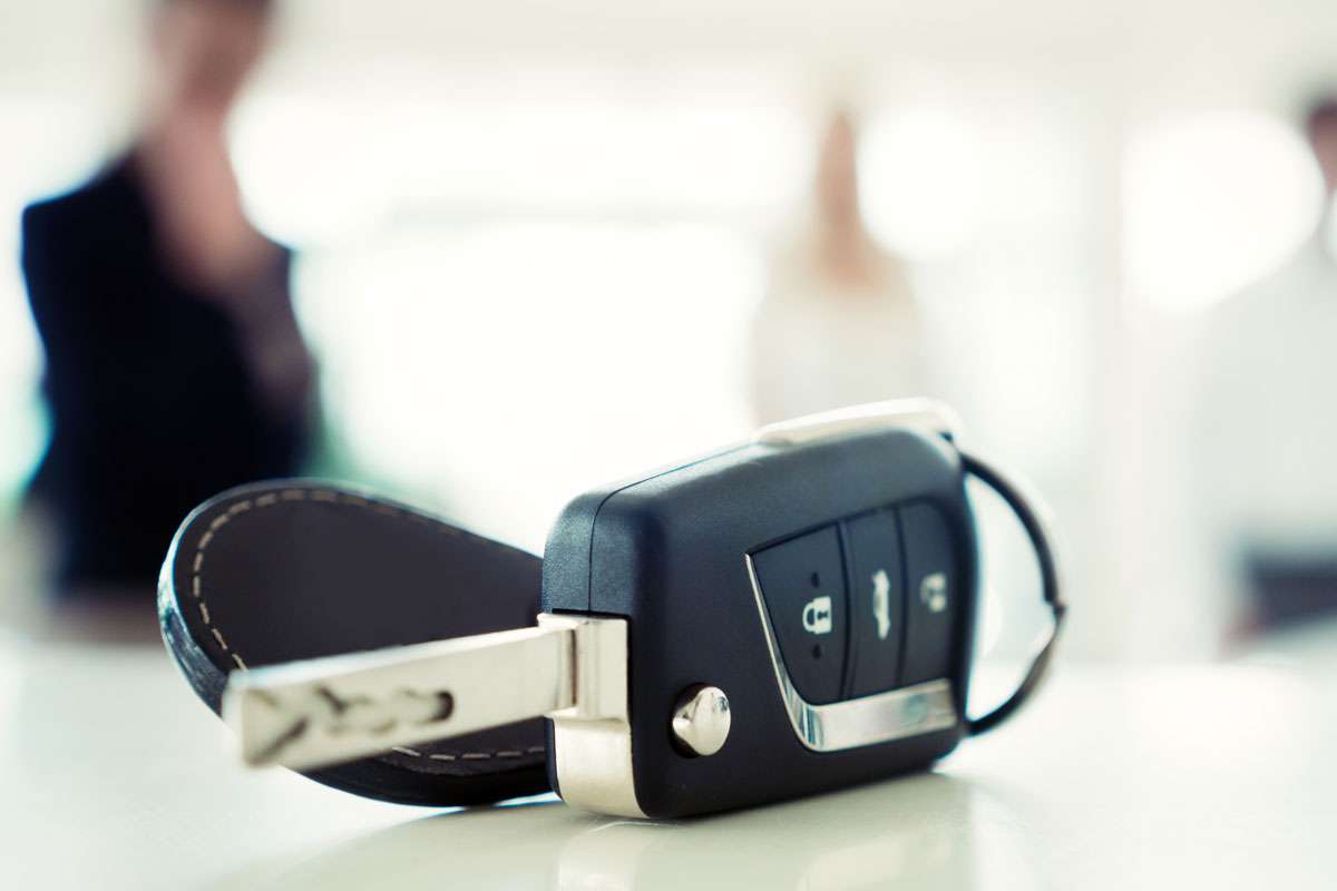 Car key fob on table, blurred background.